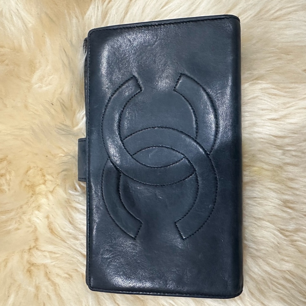 Chanel pre owned black lambskin wallet in a fair condition
